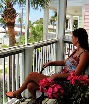 a lady relaxing on the private balcony of Lucky Catch condo